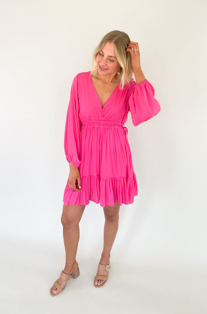 This Pinky Elastic Waistband V Neck Dress is perfect for a dinner date or special event. The baby doll shaped v neck provides a flirty and unique look while the tiered bottom adds a fun flounce. We are loving the elastic waist. It provide comfort and confidence with a great silhouette. 
