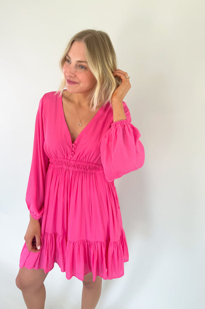 This Pinky Elastic Waistband V Neck Dress is perfect for a dinner date or special event. The baby doll shaped v neck provides a flirty and unique look while the tiered bottom adds a fun flounce. We are loving the elastic waist. It provide comfort and confidence with a great silhouette. 
