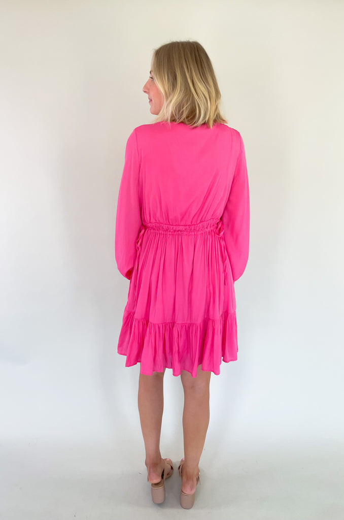 This Pinky Elastic Waistband V Neck Dress is perfect for a dinner date or special event. The baby doll shaped v neck provides a flirty and unique look while the tiered bottom adds a fun flounce. We are loving the elastic waist. It provide comfort and confidence with a great silhouette. 
