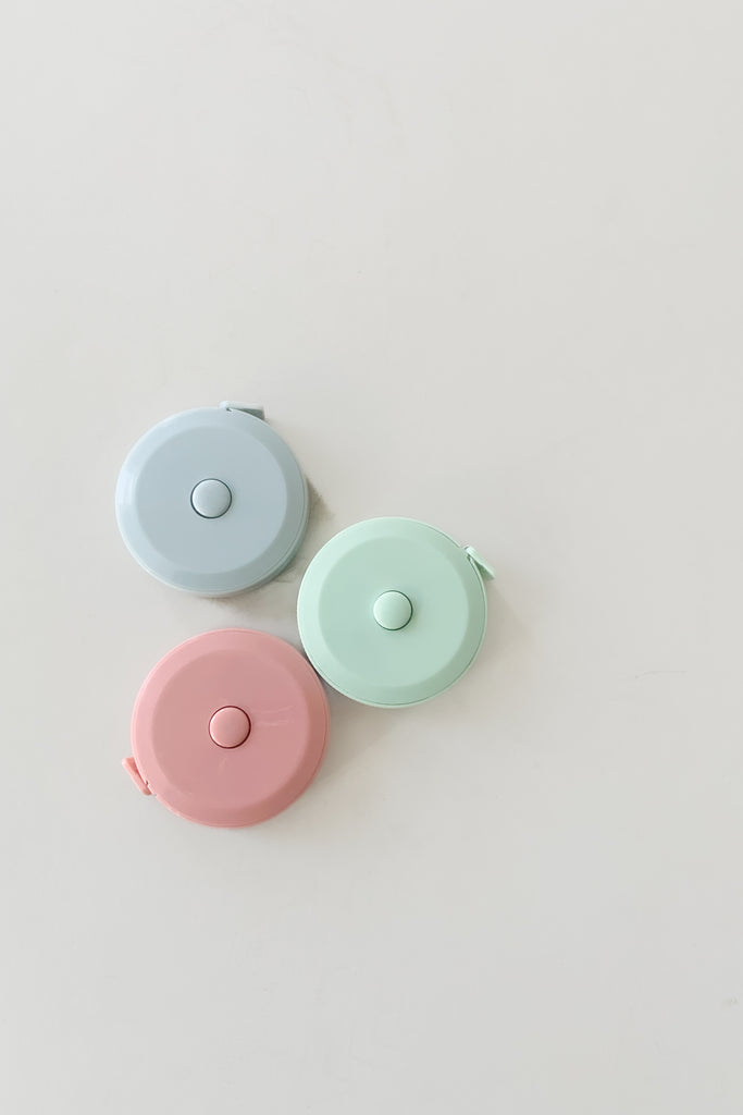 Super cute and handy 60 inch or 150cm pocket tape measure with retractable button. These are great for gifts or stocking stuffers and come in three colors. They are $2.99 each.  