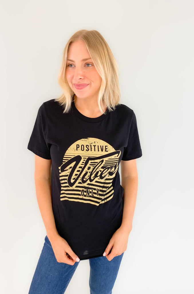 Black tee with a tan graphic that says "positive Vibes Only"