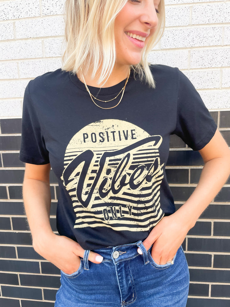 Black tee with a tan graphic that says "positive Vibes Only"