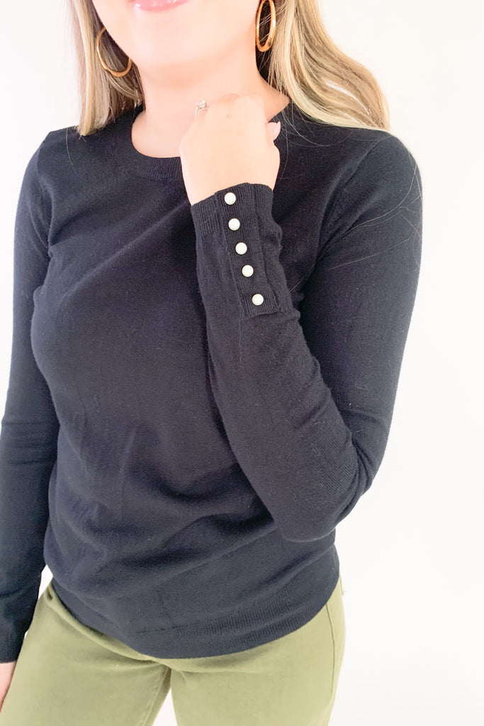 This cozy Pullover Sweater with Pearls from Molly Bracken is perfect for the holidays. Semi-fitted and complete with pearl buttons and cuffs, it's stylish and fun yet extremely comfortable. Add a touch of glam to your wardrobe with this classic piece!