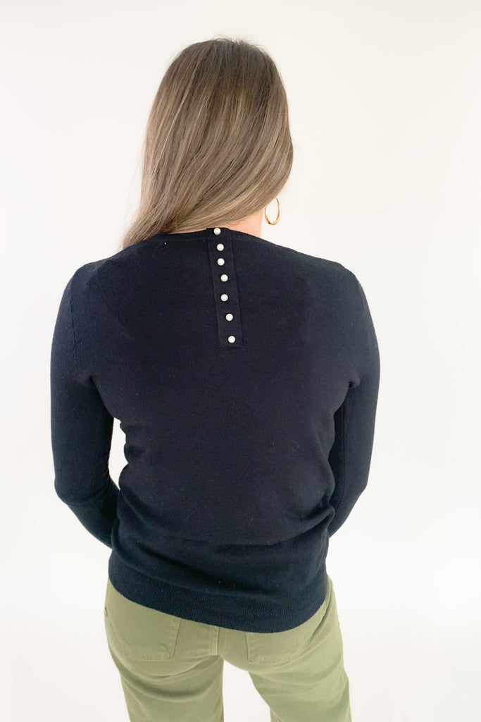 This cozy Pullover Sweater with Pearls from Molly Bracken is perfect for the holidays. Semi-fitted and complete with pearl buttons and cuffs, it's stylish and fun yet extremely comfortable. Add a touch of glam to your wardrobe with this classic piece!