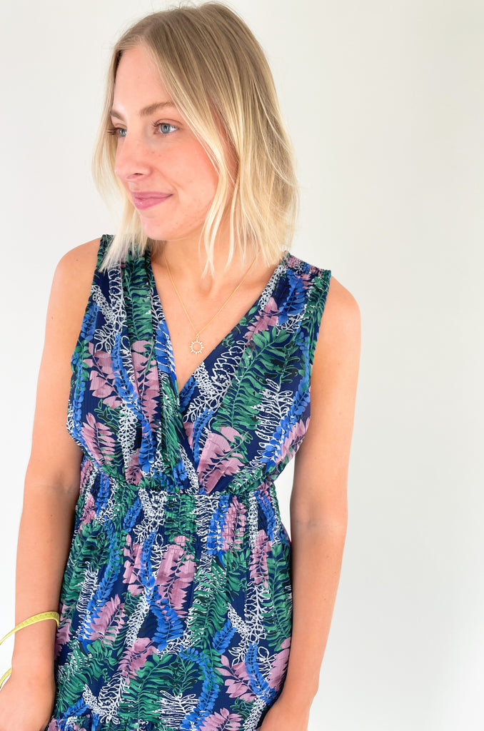 Relax and remain stylish in the Rainforest Ruffle Maxi Dress. This v neck dress features a wide strap with a tiered body that is made of a beautiful mix of blues, purples and greens. Its relaxed fit and lightweight material make it the perfect maxi dress for summer days. 
