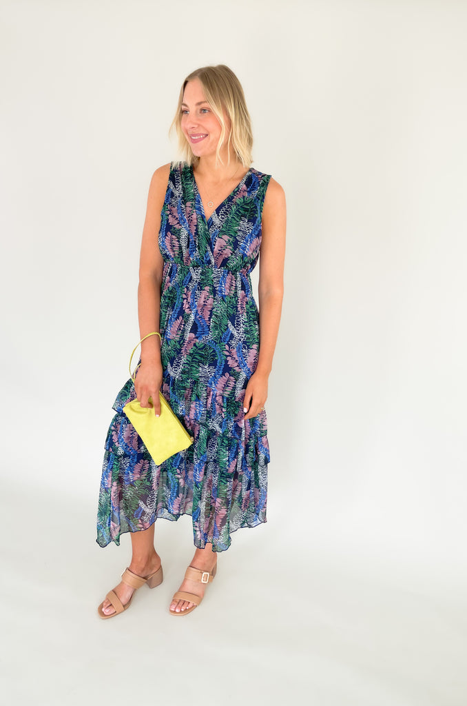 Relax and remain stylish in the Rainforest Ruffle Maxi Dress. This v neck dress features a wide strap with a tiered body that is made of a beautiful mix of blues, purples and greens. Its relaxed fit and lightweight material make it the perfect maxi dress for summer days. 