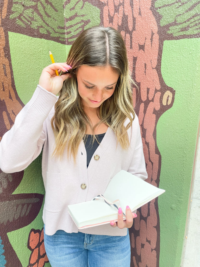 Cozy up in our new Rockwell Knit Cardigan! This classic cardigan features a beautiful knit material, three stylish tortoise buttons, and two conveniently-sized pockets for all of your essentials- choose between two colors to complete your look