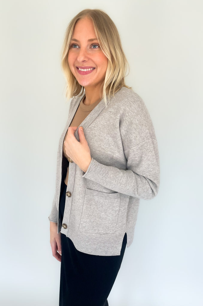 Cozy up in our new Rockwell Knit Cardigan! This classic cardigan features a beautiful knit material, three stylish tortoise buttons, and two conveniently-sized pockets for all of your essentials- choose between two colors to complete your look