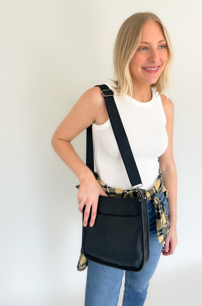The Rosie Faux Leather Crossbody is a staple handbag! This faux leather bag has a soft a durable feel! There is a detachable, tonal, and adjustable strap that comes with the Rosie, or an Adjustable Fabric Guitar Strap is also available! Both options are so cute! This handbag is the smaller version of one of our best sellers, the Chloe Faux Leather Handbag with Guitar Strap. 