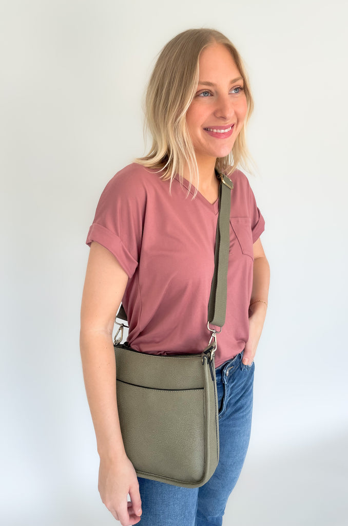 The Rosie Faux Leather Crossbody is a staple handbag! This faux leather bag has a soft a durable feel! There is a detachable, tonal, and adjustable strap that comes with the Rosie, or an Adjustable Fabric Guitar Strap is also available! Both options are so cute! This handbag is the smaller version of one of our best sellers, the Chloe Faux Leather Handbag with Guitar Strap. 
