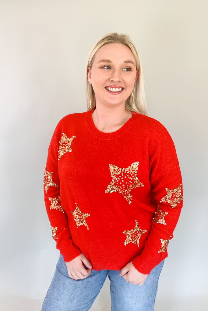 Look festive this season in our Sequin Star + Pearl Sweater! Enjoy the luxurious shade of classic red and sparkly sequins with a sprinkle of pearl accents. It's eye-catching and unique, so get ready for all the compliments! Featuring a round neckline and loose sweater body, this sweater has a very great fit. 