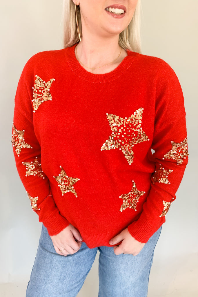 Look festive this season in our Sequin Star + Pearl Sweater! Enjoy the luxurious shade of classic red and sparkly sequins with a sprinkle of pearl accents. It's eye-catching and unique, so get ready for all the compliments! Featuring a round neckline and loose sweater body, this sweater has a very great fit. 