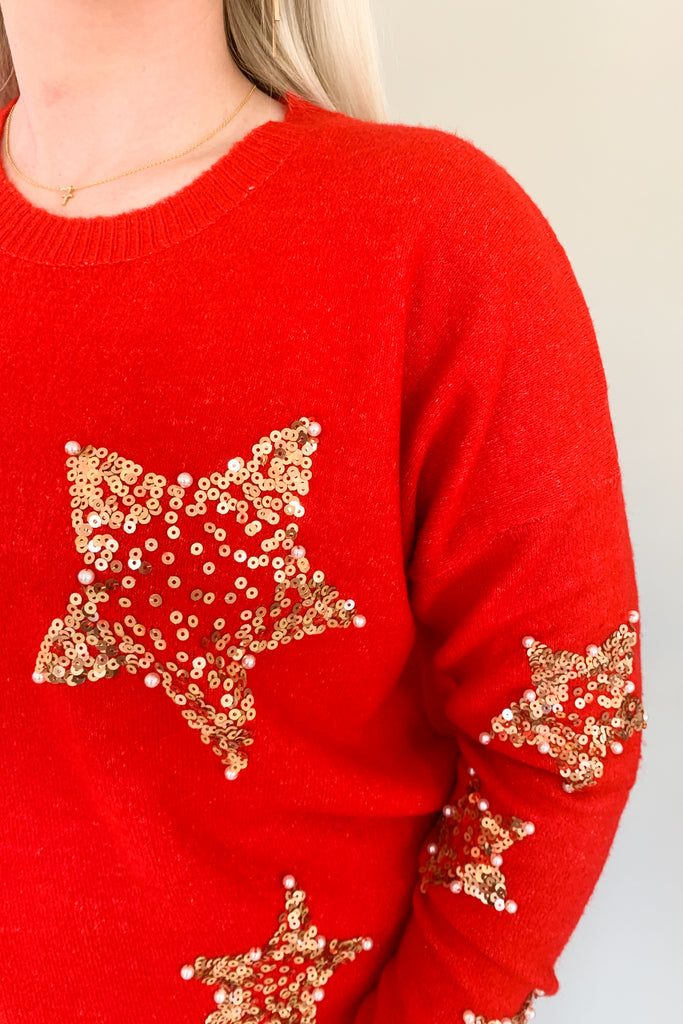 Look festive this season in our Sequin Star + Pearl Sweater! Enjoy the luxurious shade of classic red and sparkly sequins with a sprinkle of pearl accents. It's eye-catching and unique, so get ready for all the compliments! Featuring a round neckline and loose sweater body, this sweater has a very great fit. 