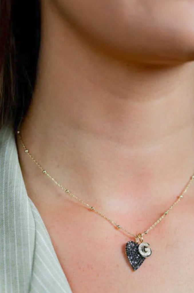 The Sis Kiss Baby Ball Chain Necklace is here to add some bling to your look! It features a gold chain with a ball pendant for subtle glam and shine. Choose your favorite charms to completely customize your look!