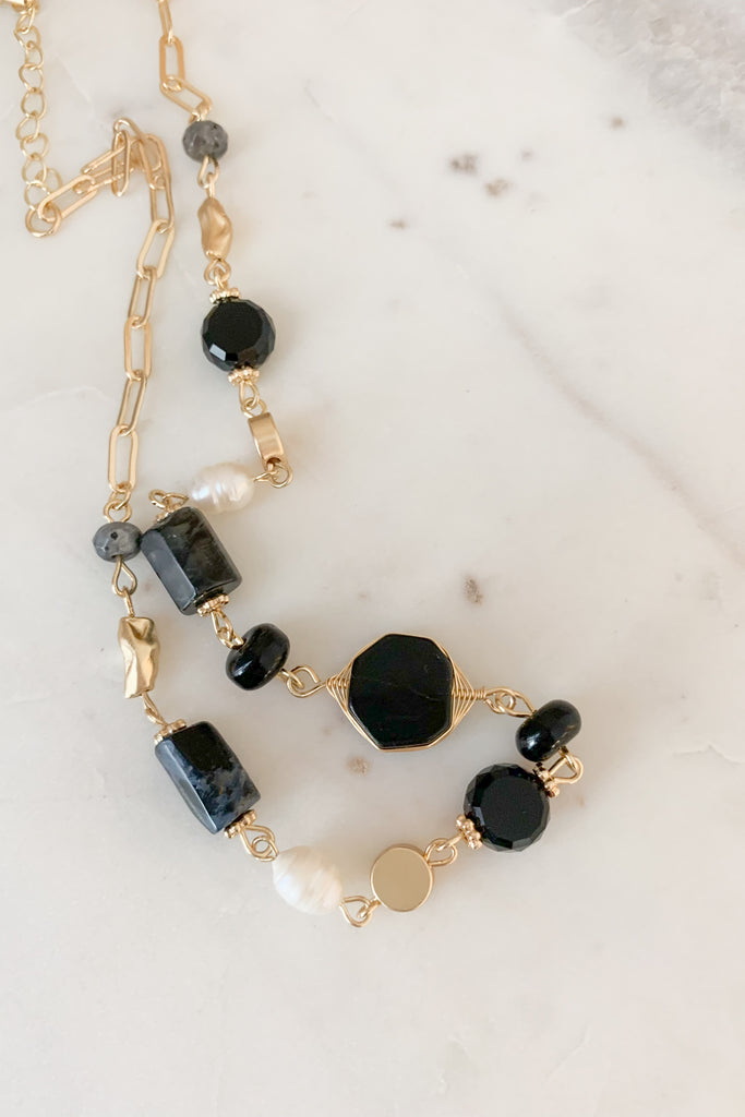 The Stone Beaded Black Collar Necklace is so pretty and timeless. Because it is black and pearl, this necklace will go with everything. It's elevated and classic, while matching the rest of your gold jewelry. 