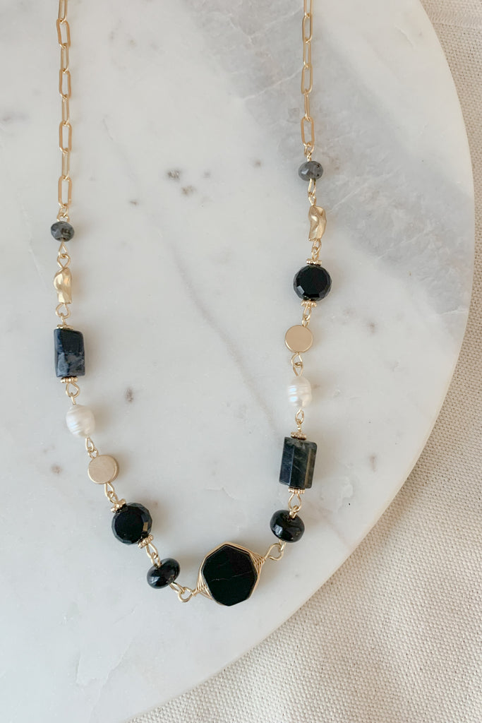 The Stone Beaded Black Collar Necklace is so pretty and timeless. Because it is black and pearl, this necklace will go with everything. It's elevated and classic, while matching the rest of your gold jewelry. 