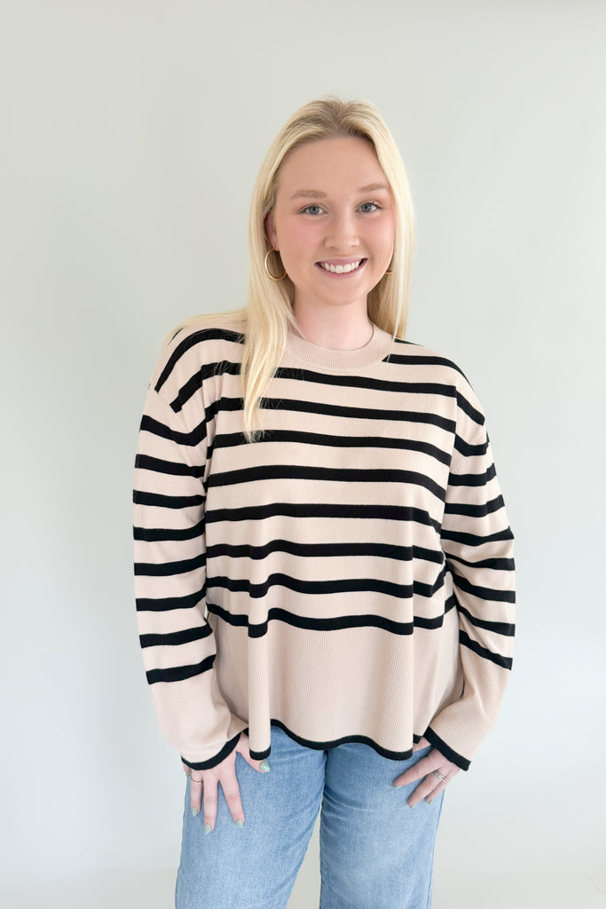 Stay warm and stylish with Suzy Striped Cashmere Sweater. This lightweight sweater features black and beige horizontal stripes, as well as side slits for comfort and an elevated fit and feel. It's a timeless piece than can easily be dressed up or down.  