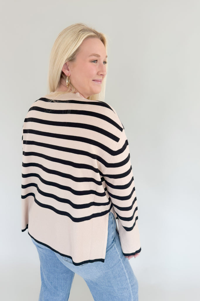 Stay warm and stylish with Suzy Striped Cashmere Sweater. This lightweight sweater features black and beige horizontal stripes, as well as side slits for comfort and an elevated fit and feel. It's a timeless piece than can easily be dressed up or down.  