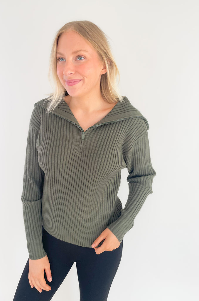 The Elan Sweater with Large Zip Collar is so elevated, yet comfortable! If you are looking for those everyday pieces that feel great, but also can be work to work or special events, this is it. The moss green color is perfect for fall and the details are stunning! It has a ribbed knit fabric, 3/4 zip front, and a large preppy inspired collar. 