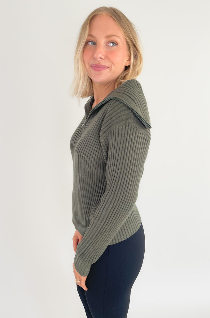The Elan Sweater with Large Zip Collar is so elevated, yet comfortable! If you are looking for those everyday pieces that feel great, but also can be work to work or special events, this is it. The moss green color is perfect for fall and the details are stunning! It has a ribbed knit fabric, 3/4 zip front, and a large preppy inspired collar. 