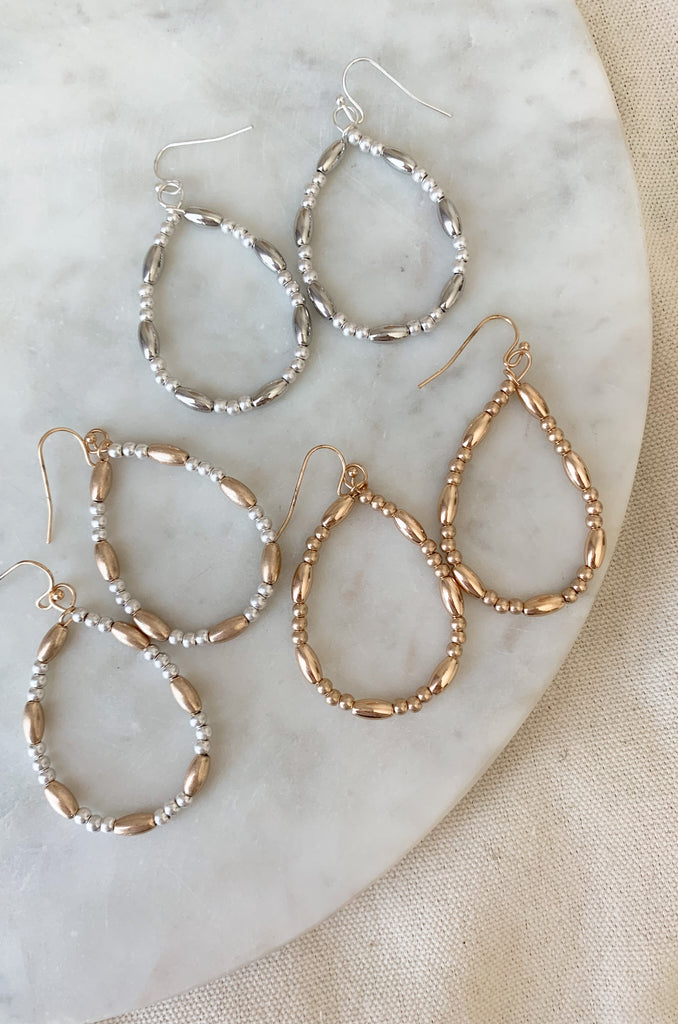 Make a fashion statement with these stylish and lightweight Teardrop Long & Ball Beaded Earrings. Available in gold, silver, and mixed metal, they feature a multilayered design with teardrop shaped accents and ball and oval beaded details. The perfect addition to any outfit!