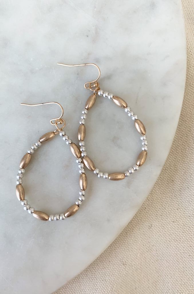 Make a fashion statement with these stylish and lightweight Teardrop Long & Ball Beaded Earrings. Available in gold, silver, and mixed metal, they feature a multilayered design with teardrop shaped accents and ball and oval beaded details. The perfect addition to any outfit!