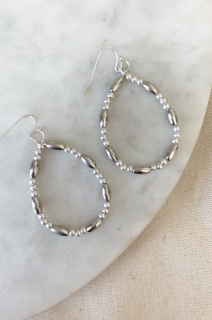 Make a fashion statement with these stylish and lightweight Teardrop Long & Ball Beaded Earrings. Available in gold, silver, and mixed metal, they feature a multilayered design with teardrop shaped accents and ball and oval beaded details. The perfect addition to any outfit!