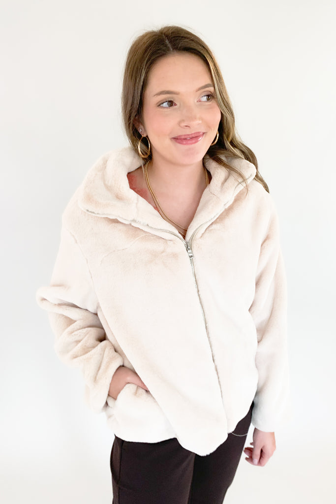 Stay warm and look great in the Teddy Cream Zip Jacket! Soft, creamy teddy material is perfectly paired with a satin lining for a stylish, yet cozy look. The front zip makes it hassle-free and perfect for any holiday occasion. 