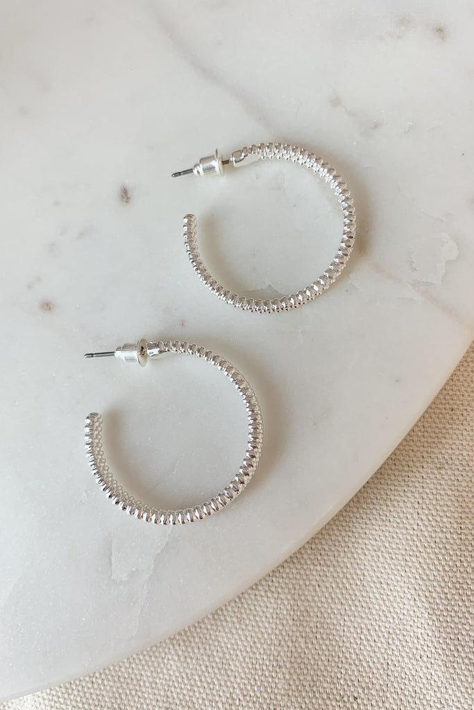 The Textured Medium Hoop Earring is a great everyday hoop. It's the perfect size with just the right amount of detail to elevated any look. Choose between gold or silver. 