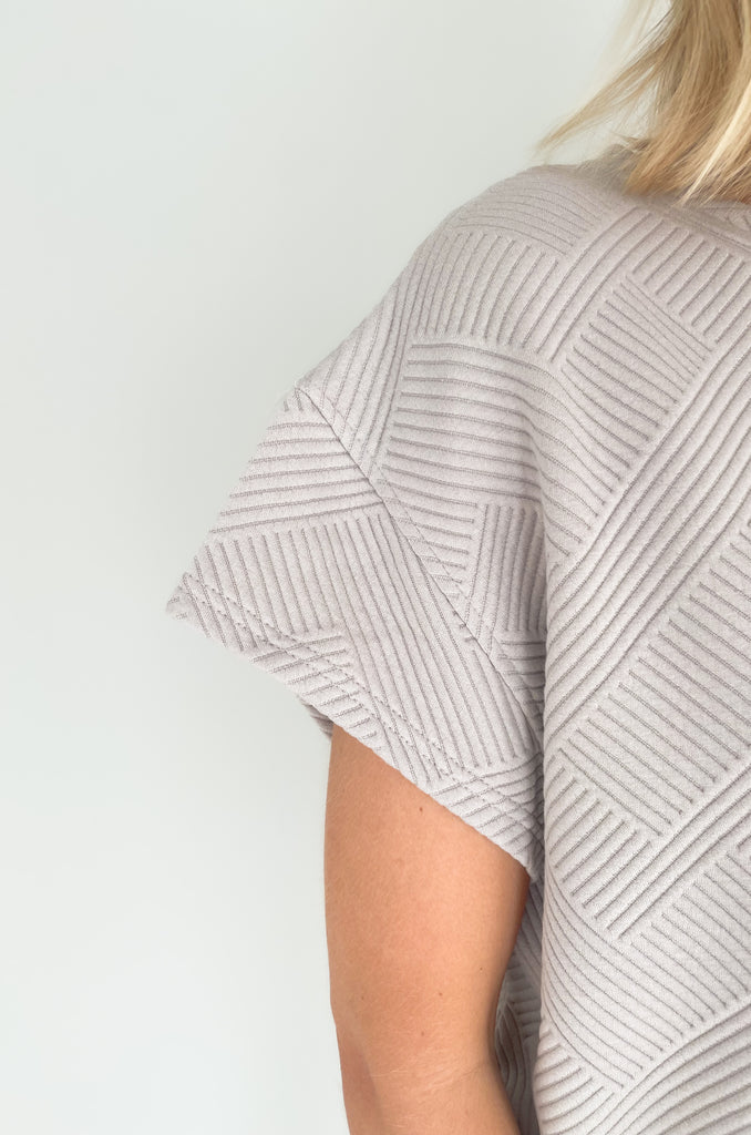 textured round neck short sleeve sweater. Pairs back to matching shorts or cropped wide leg lounge pants. It's the perfect set for comfort and style. 
