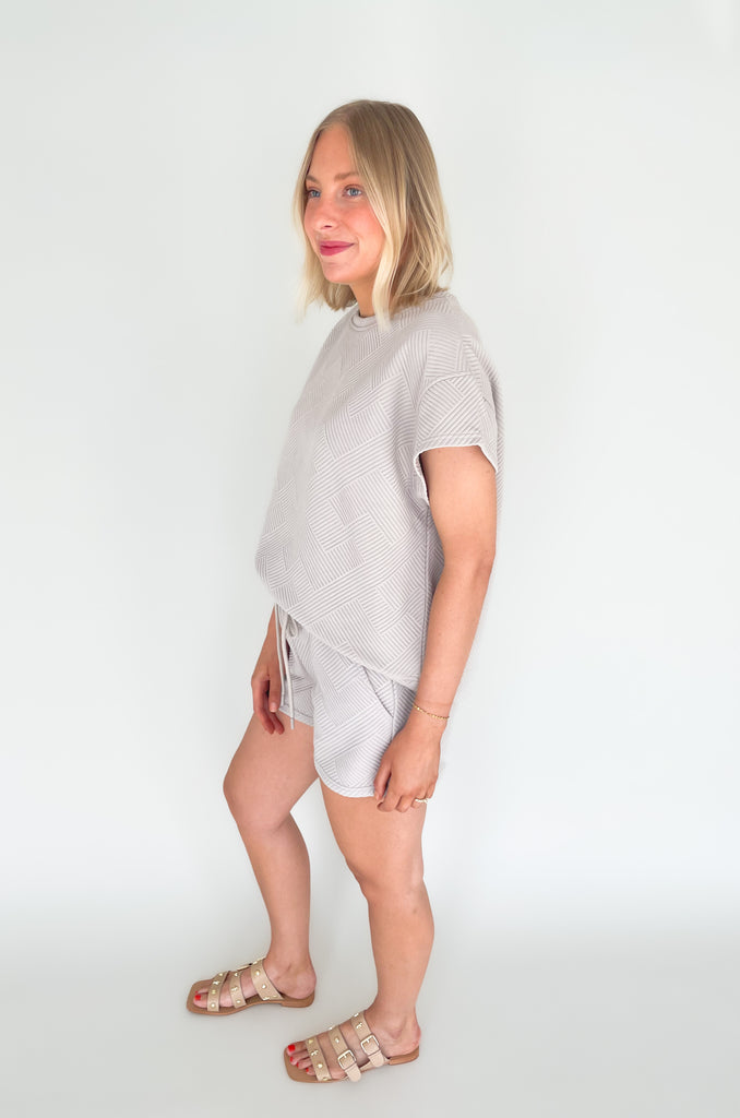 textured round neck short sleeve sweater. Pairs back to matching shorts or cropped wide leg lounge pants. It's the perfect set for comfort and style. 