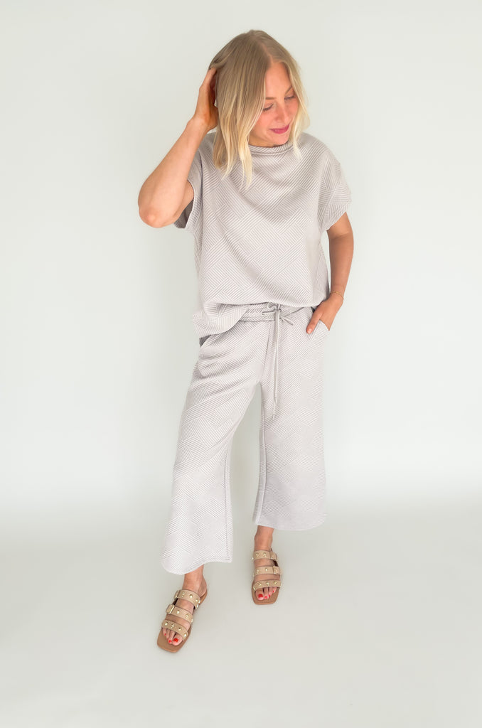 textured round neck short sleeve sweater. Pairs back to matching shorts or cropped wide leg lounge pants. It's the perfect set for comfort and style. 