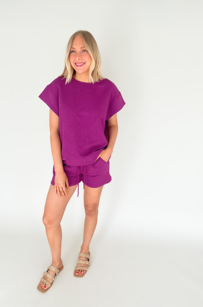 textured round neck short sleeve sweater. Pairs back to matching shorts or cropped wide leg lounge pants. It's the perfect set for comfort and style. 
