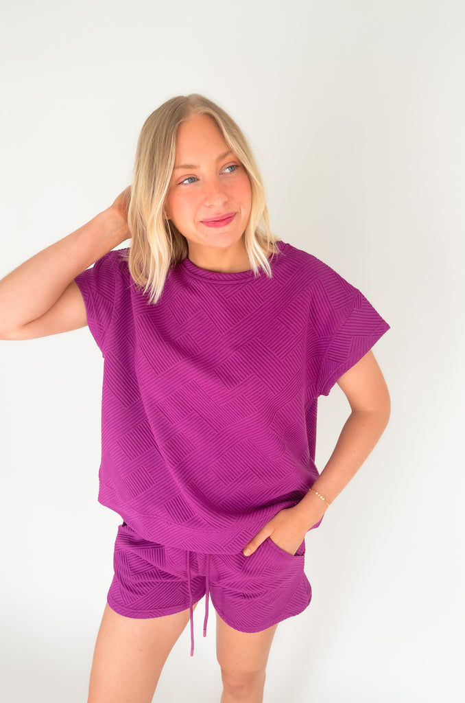textured round neck short sleeve sweater. Pairs back to matching shorts or cropped wide leg lounge pants. It's the perfect set for comfort and style. 