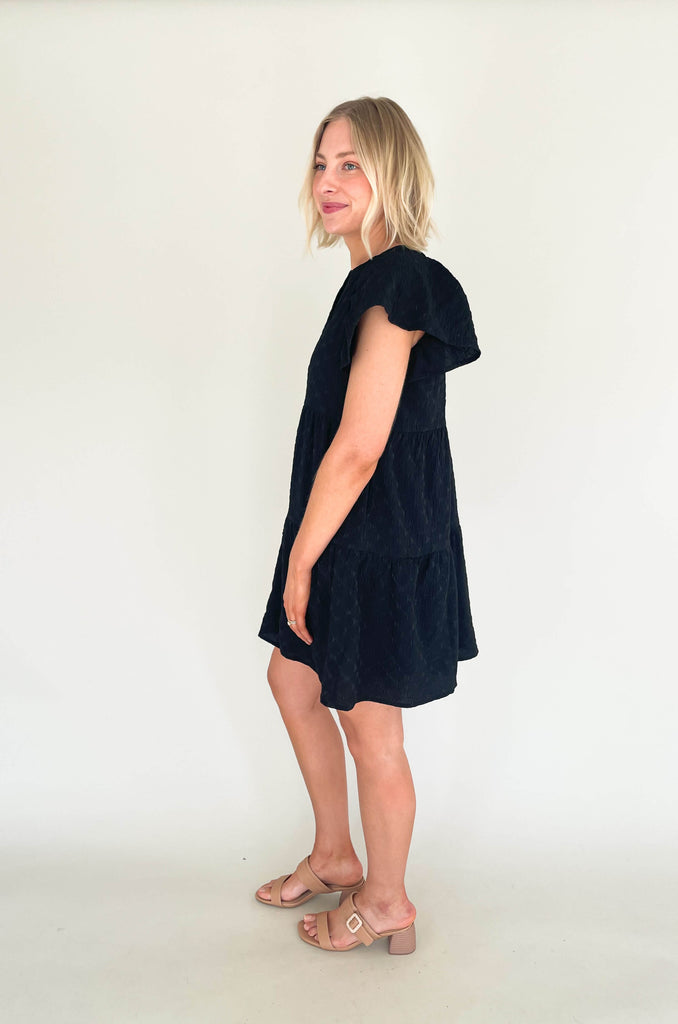 Introducing the Too Perfect Flare Sleeve Tiered Dress! Make a statement and stand out in this textured dress that flaunts your style and shows off your personality. Featuring a v-neckline and tiered design, it will make you feel like a million bucks. Available in black or yellow if you dare to be bold. This dress also features a built-in liner for more coverage. 