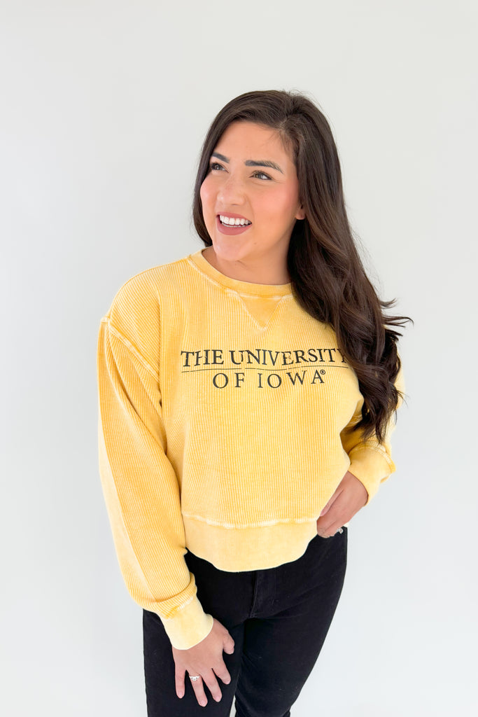 Stay cozy and show your team spirit with this fun University of Iowa Emblem Pullover! It features a unique, bright yellow corded material with block text, making it perfect for fans of the Hawkeyes. Look great and stay comfortable on game day, or snag one of these as a gift!