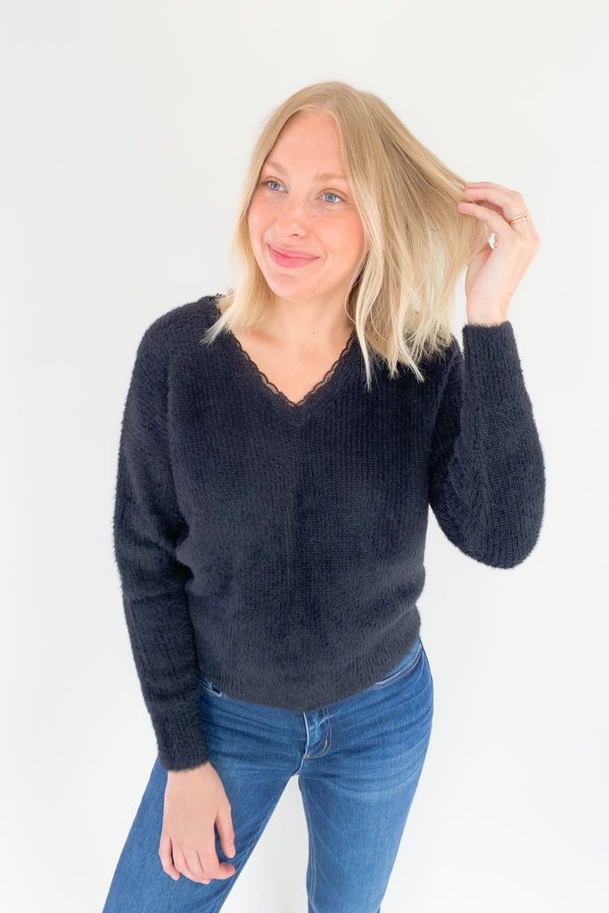Look and feel your best in this ultra soft V Neck Knit Sweater with Lace Trim by Molly Bracken! Perfect for all occasions, the elevated lace trim detail will give you an effortless and chic look. Available in jet black, this must-have piece is perfect for any wardrobe.
