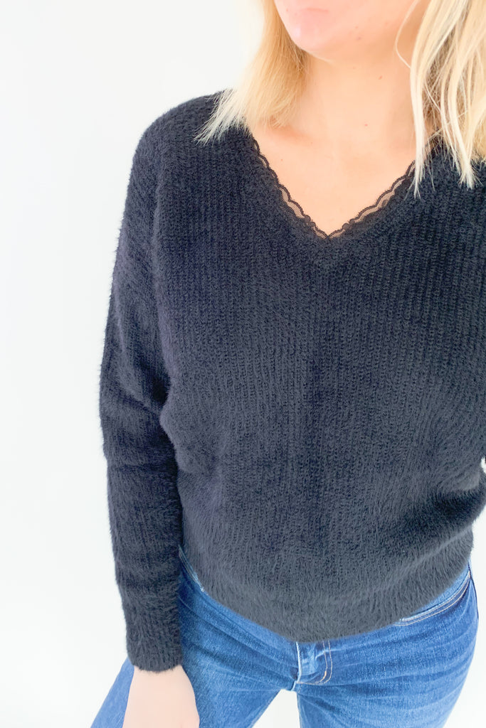 Look and feel your best in this ultra soft V Neck Knit Sweater with Lace Trim by Molly Bracken! Perfect for all occasions, the elevated lace trim detail will give you an effortless and chic look. Available in jet black, this must-have piece is perfect for any wardrobe.