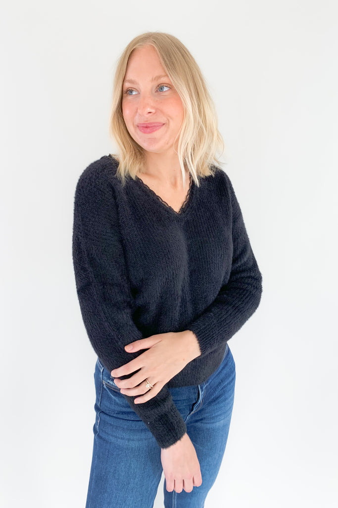 Look and feel your best in this ultra soft V Neck Knit Sweater with Lace Trim by Molly Bracken! Perfect for all occasions, the elevated lace trim detail will give you an effortless and chic look. Available in jet black, this must-have piece is perfect for any wardrobe.