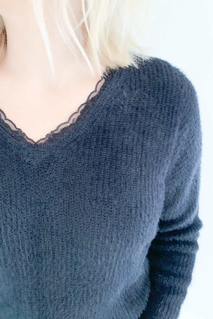 Look and feel your best in this ultra soft V Neck Knit Sweater with Lace Trim by Molly Bracken! Perfect for all occasions, the elevated lace trim detail will give you an effortless and chic look. Available in jet black, this must-have piece is perfect for any wardrobe.