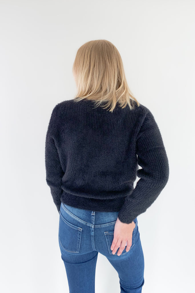 Look and feel your best in this ultra soft V Neck Knit Sweater with Lace Trim by Molly Bracken! Perfect for all occasions, the elevated lace trim detail will give you an effortless and chic look. Available in jet black, this must-have piece is perfect for any wardrobe.