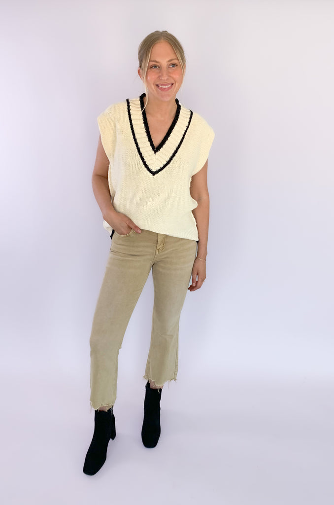 The Elan V Neck Varsity Sweater Vest is so chic and elevated! We love the cozy thick sweater material and contrast details. Round the v-neckline and bottom hem, there is contrast stitching. 