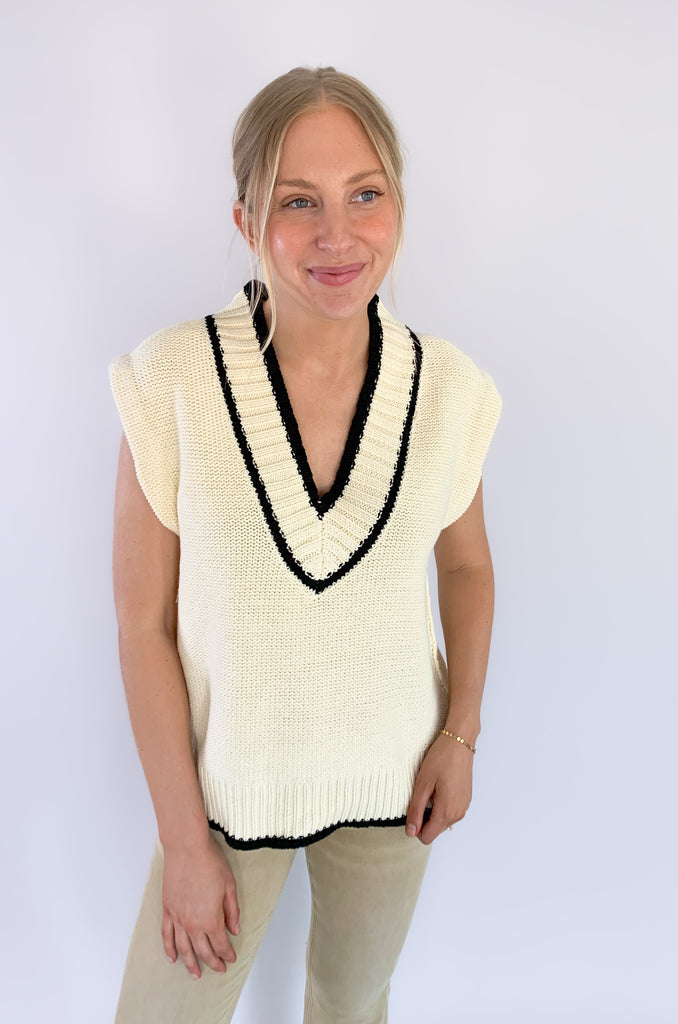 The Elan V Neck Varsity Sweater Vest is so chic and elevated! We love the cozy thick sweater material and contrast details. Round the v-neckline and bottom hem, there is contrast stitching. 