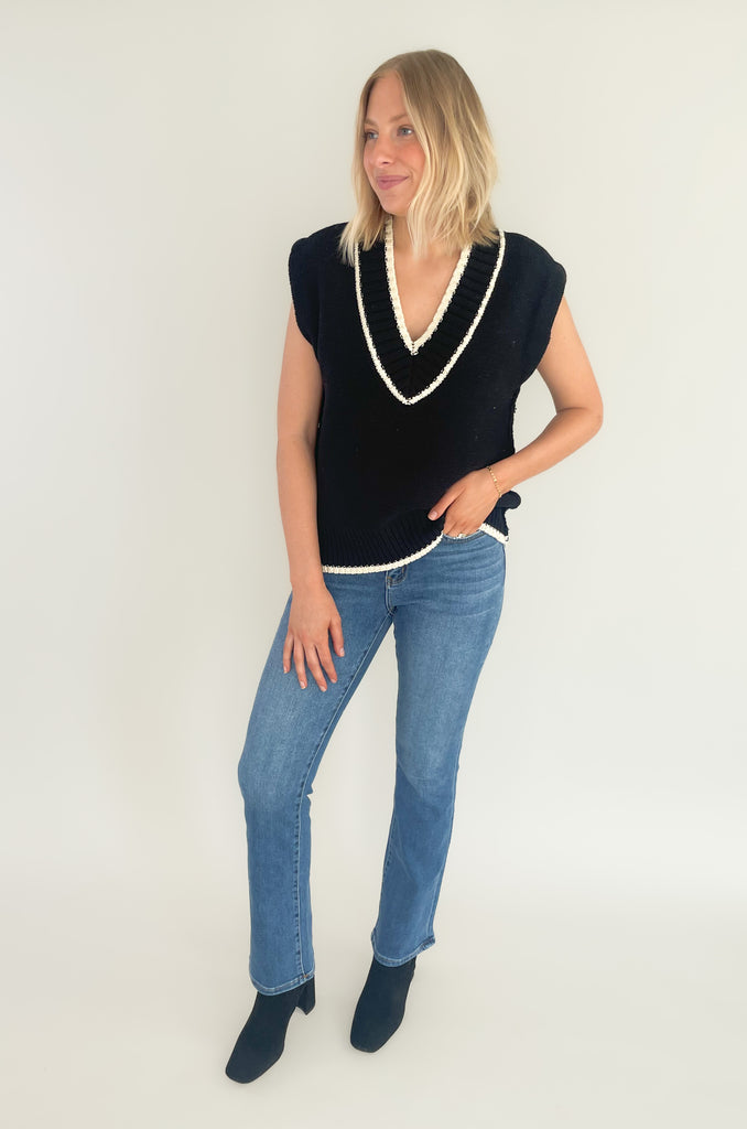 The Elan V Neck Varsity Sweater Vest is so chic and elevated! We love the cozy thick sweater material and contrast details. Round the v-neckline and bottom hem, there is contrast stitching. 