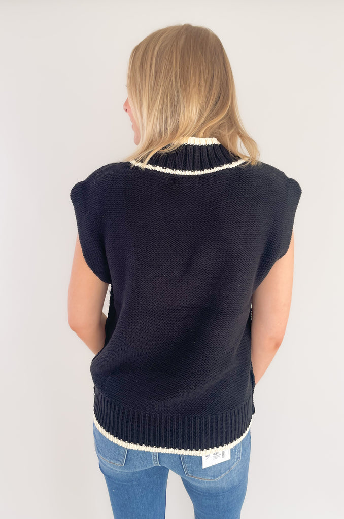 The Elan V Neck Varsity Sweater Vest is so chic and elevated! We love the cozy thick sweater material and contrast details. Round the v-neckline and bottom hem, there is contrast stitching. 