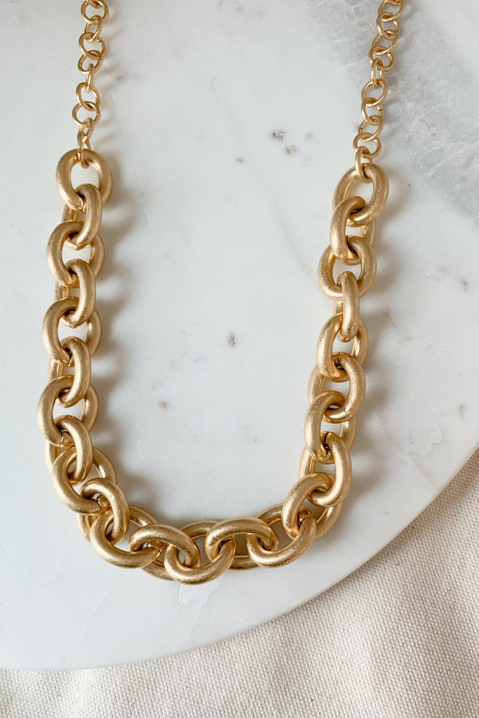The Vintage Chunky Metal Gold Chain Necklace is right on trend this season, adding a little personality to finish off any look. It's a big chunky necklace with a worn vintage plating. This necklace is 22" long with a 3" extender