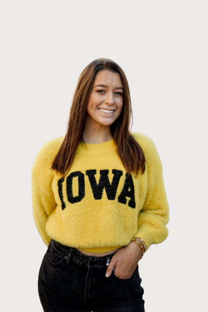 The Iowa Eyelash Crop Sweater  is so cute and unique! If you are looking to standout piece for game day, this style is a must-have. It's soft, bright yellow, with a black "IOWA" text. It seriously feels like a dream!!
