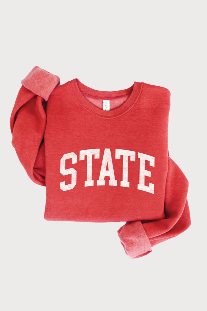 Sport stylish comfort in the STATE Graphic Pullover! This cozy pullover features a bold STATE logo on the chest, making it the perfect way to add a touch of fun to your everyday wardrobe. This sweatshirt is perfect for Iowa State University Cyclone fans, while remaining classic for all sport teams. Grab one for yourself or gift one for the holiday season!