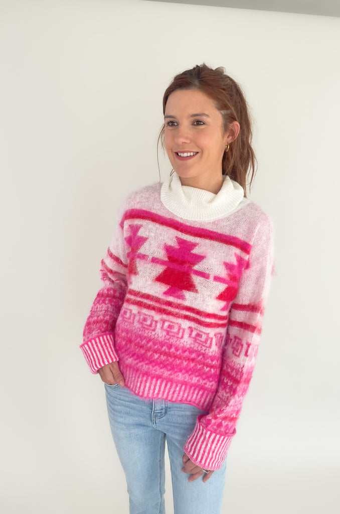 Stay cozy and stylish in this Winter Wonderland Printed Turtleneck Sweater! It features a unique holiday abstract print with an eyelash fabric for a soft, luxurious feel. It really stands out and is the perfect holiday style. We love the turtleneck and slight oversized fit that screams cozy for the holidays! 