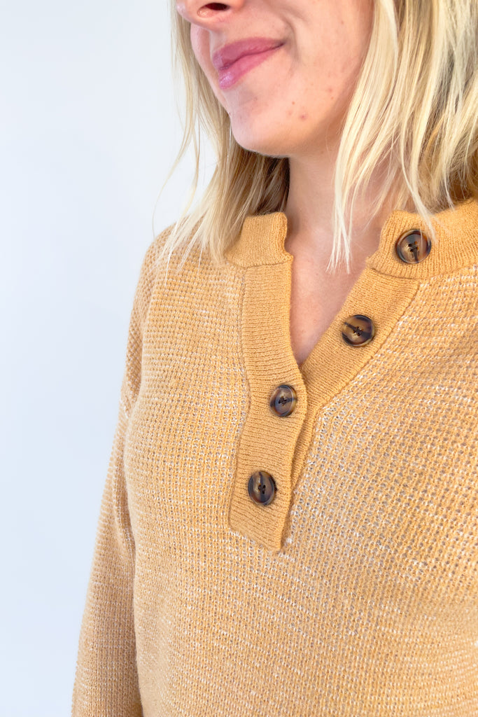 A perfect addition to your year-round wardrobe, the Wish Waffle Knit Henley offers a comfortable fit in a timeless style. Crafted with camel and white yarn and a 3/4 button up design, this henley offers a soft, stretchy feel that is perfect for everyday wear. 